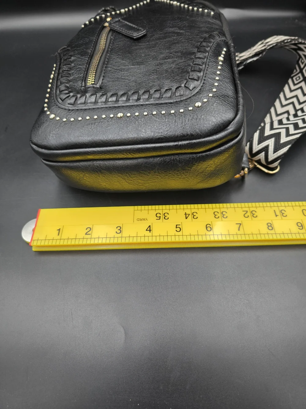 Black Studded Women's Leather Sling Backpack with Patterned Strap